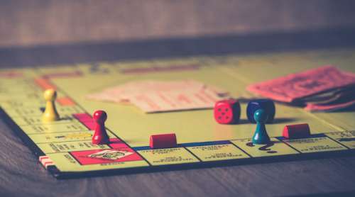 monopoly board game on brown wooden tabletop